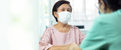 Asian American patient with surgical mask at doctor's office