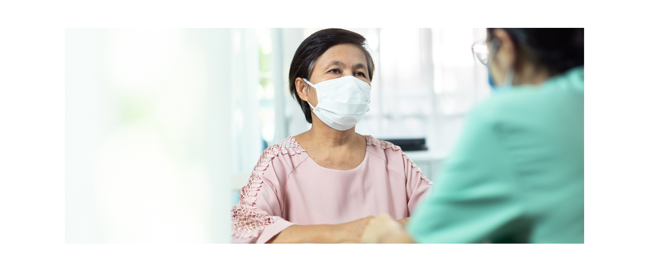 Asian American patient with surgical mask at doctor's office