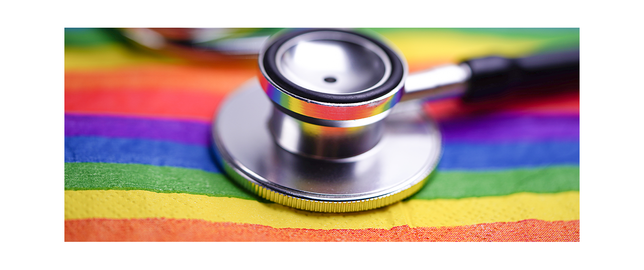 Stethoscope atop a rainbow flag 