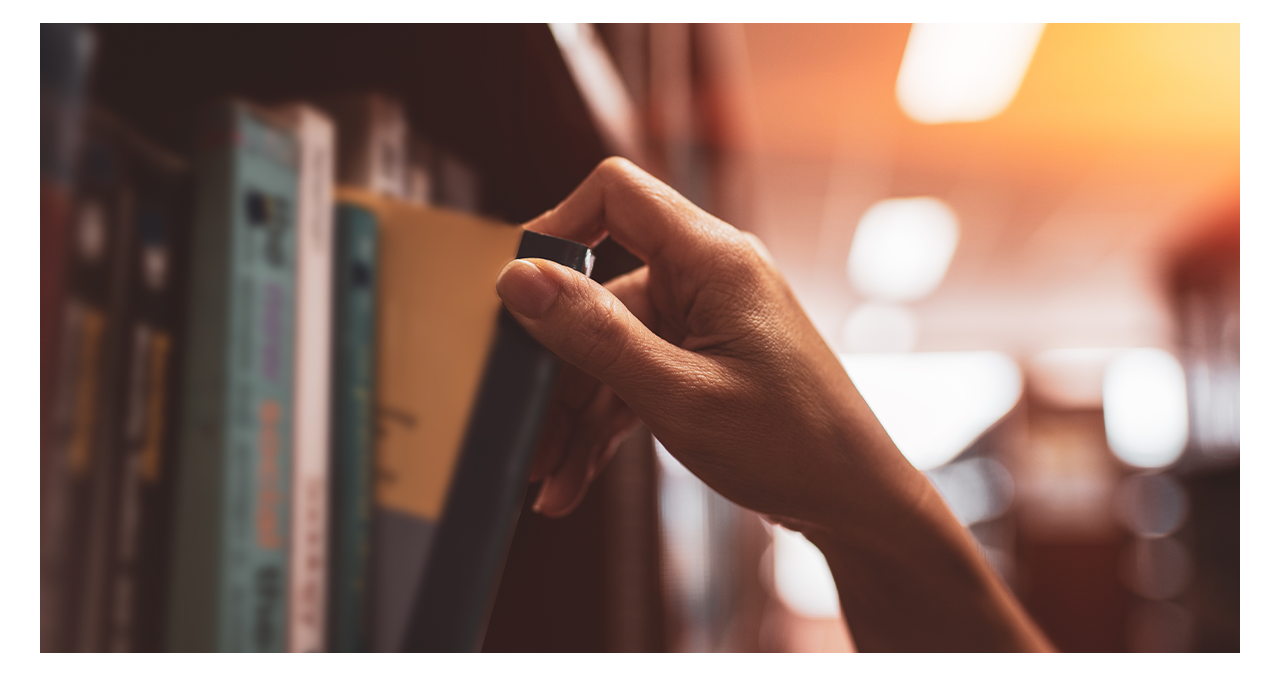 hand getting book from shelf