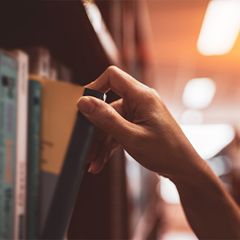 hand getting book from shelf