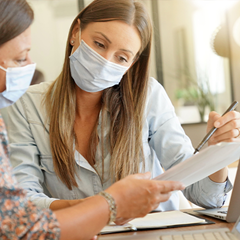 two ladies with mask reading