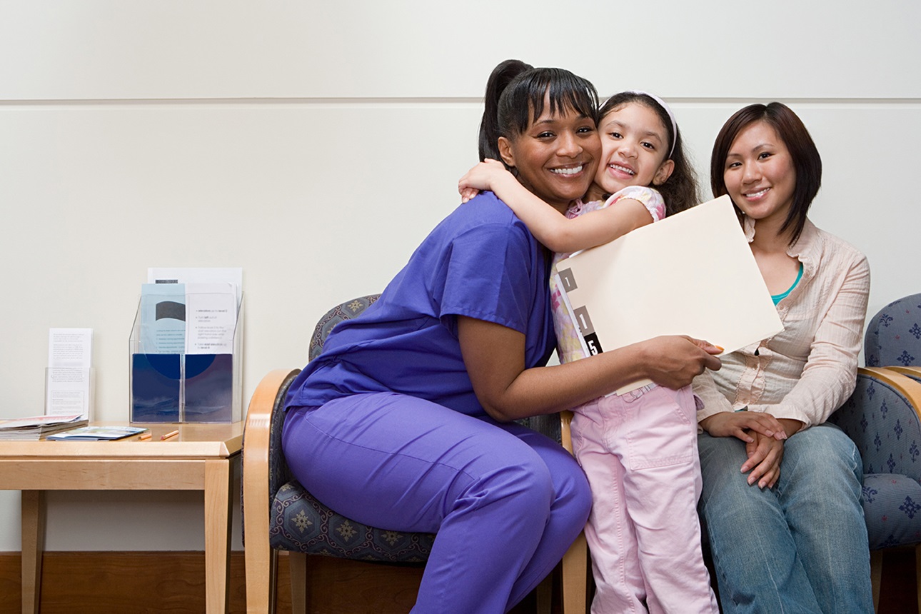 Nurse hugging a child patient